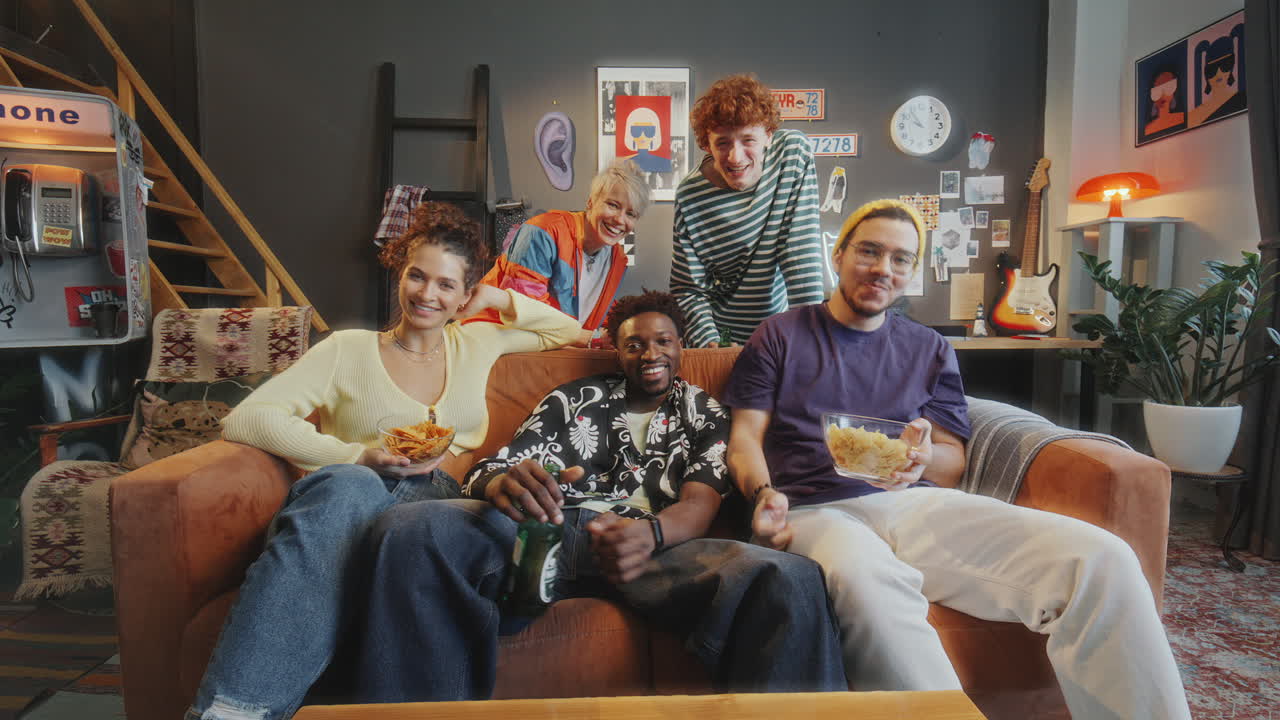 Company of Friends Watching TV Show and Laughing in Stylish Living Room
