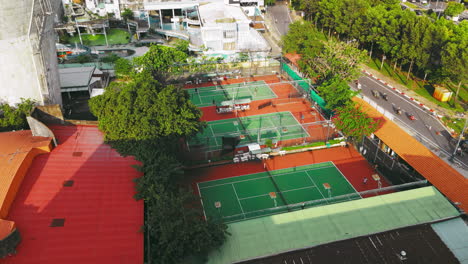 a stunning aerial view of a tennis court bathed in the warm glow of sunset
