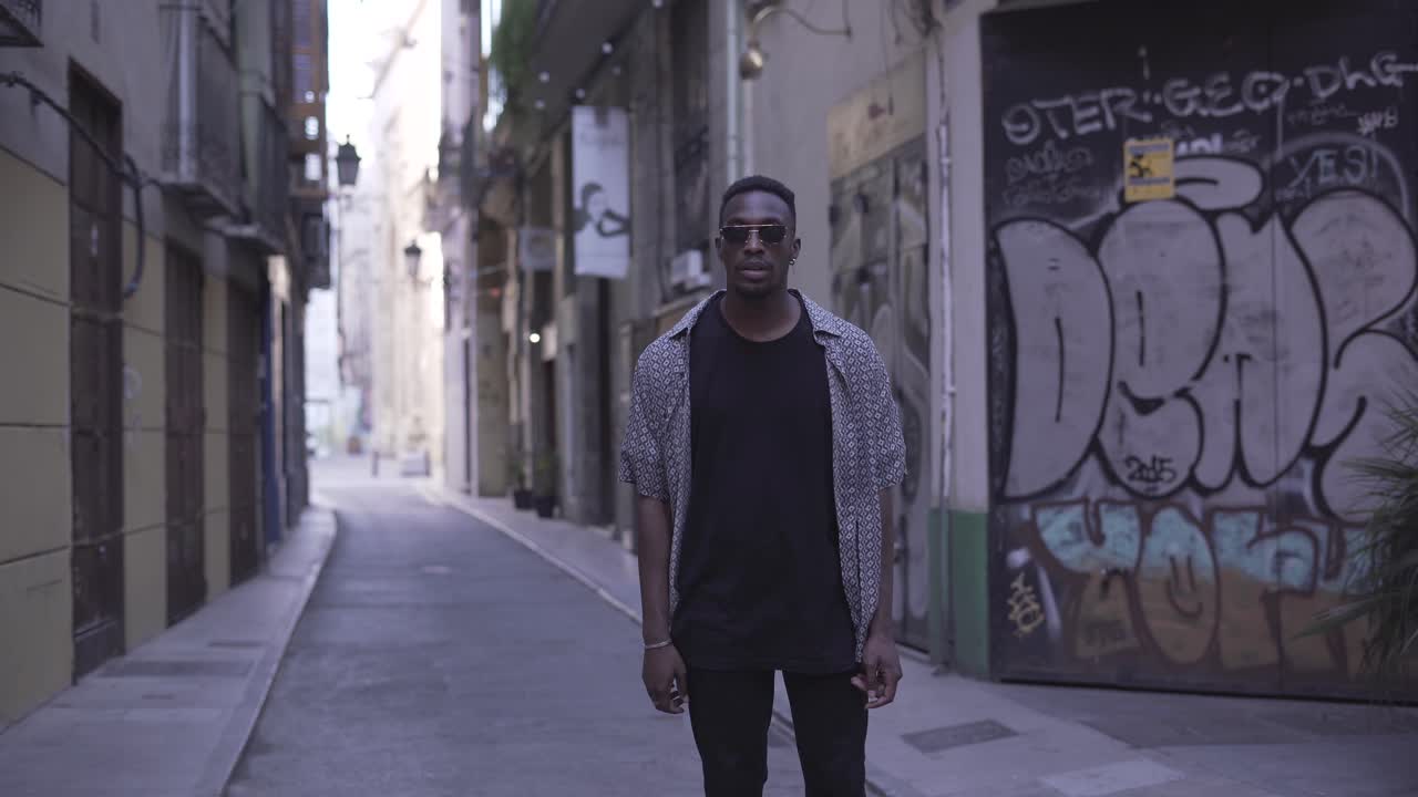 Man Running Through a Graffiti-Covered Alley