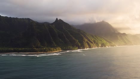 epic aerial above hawaii coast landscape of haena park, panoramic views on napali coast park with green tropical jungle mountain peaks covered by rain clouds