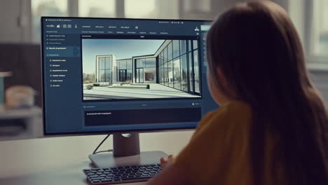child working on a computer displaying architectural designs