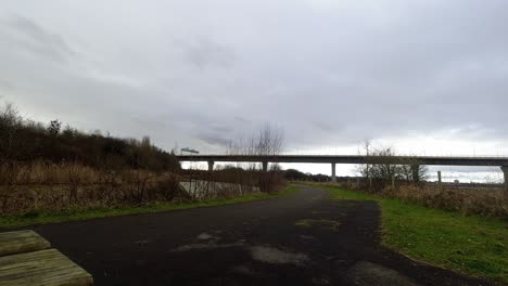 Time-lapse-traffic-rush-over-rural-UK-countryside-park-bridge-overpass-at-speed