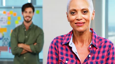 Portrait-of-executives-standing-with-arms-crossed-in-office