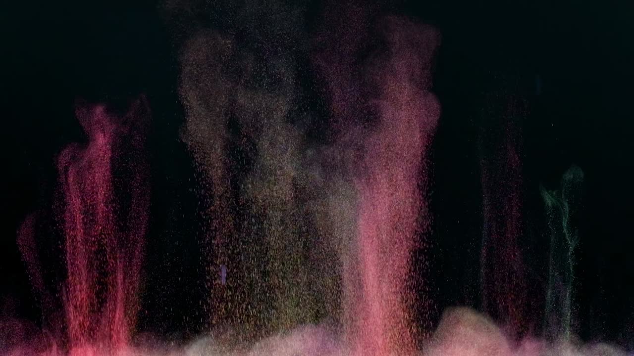 el salpico colorido de pequeñas partículas en cámara lenta