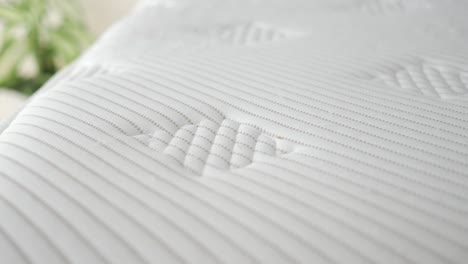 close-up of a white mattress with a quilted pattern