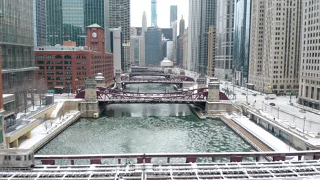 drone flies above chicago river in winter