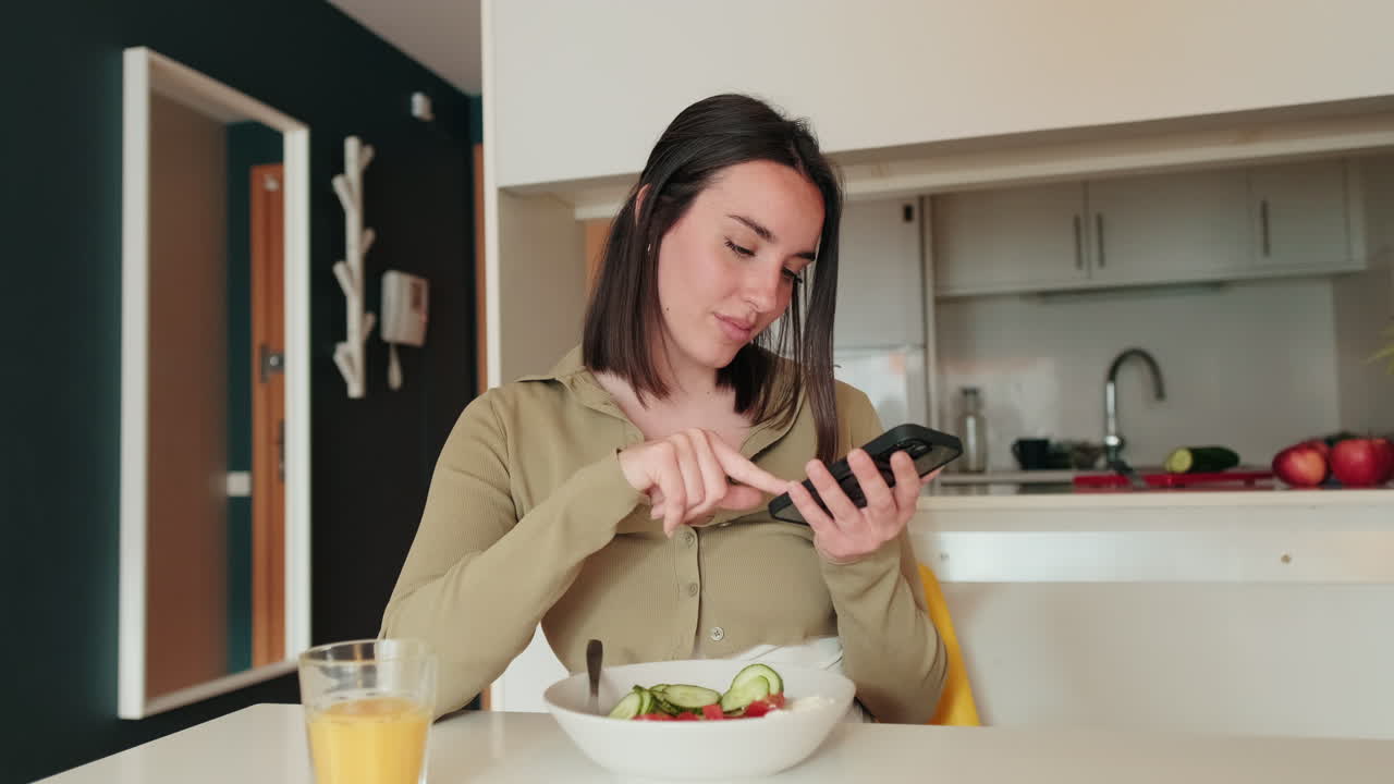Woman Using Phone While Eating Breakfast