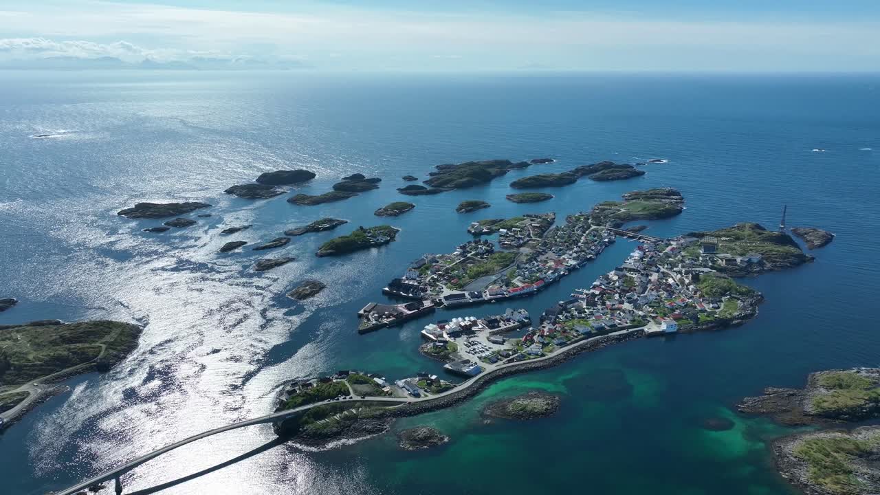 showing Henningsvaer islands surrounded by ocean under summer sun