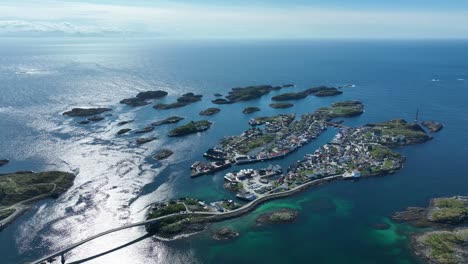 showing henningsvaer islands surrounded by ocean under summer sun