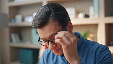 closeup man hands typing keyboard at office. tired designer rubbing eyes working