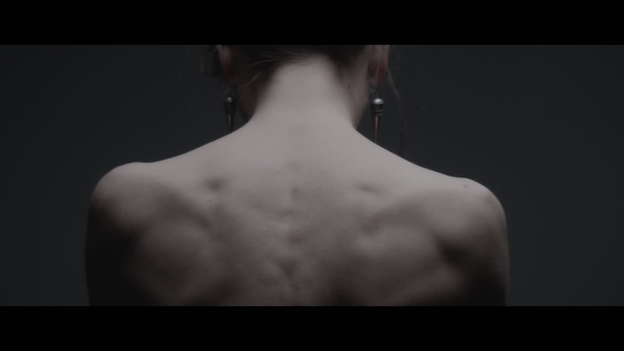 A woman dressed as mother nature shows her back