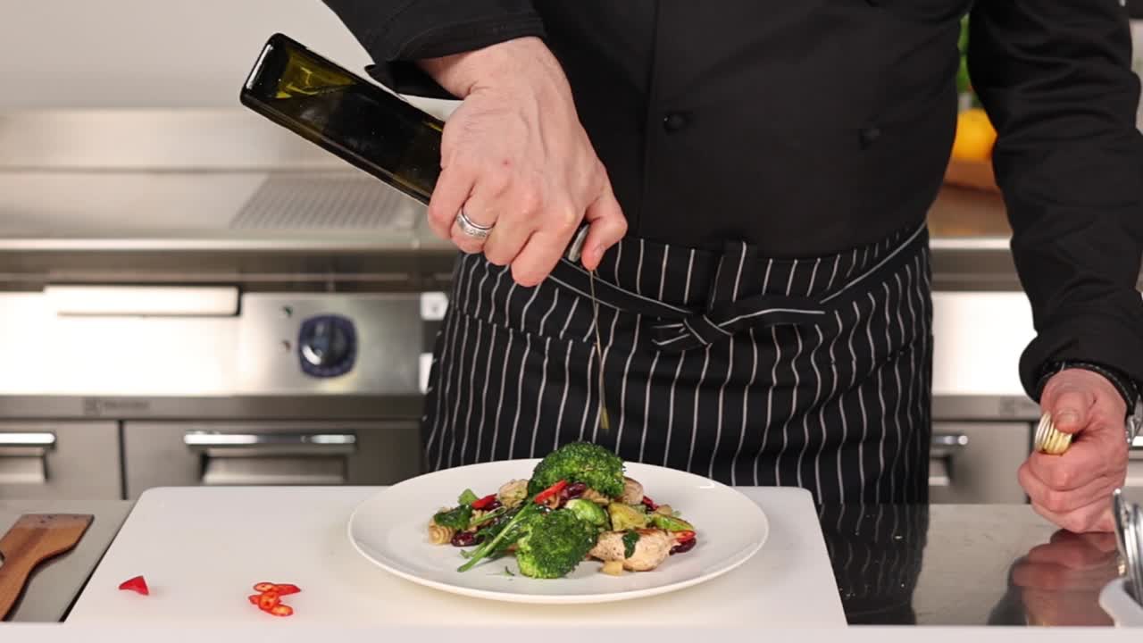 Chef Drizzling Olive Oil Over Vegetable Salad