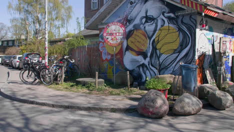 urban street art and bicycles on a sunny day near to the vibrant and iconic freetown christiania in copenhagen