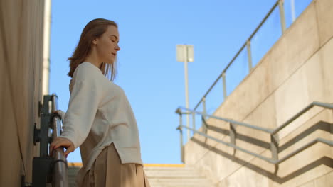 young woman posing on city stairs