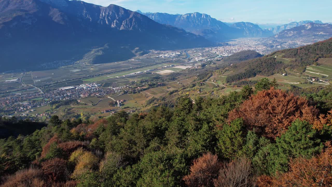 Spectacular aerial view of the city of Trento, Adige River and mountains in Italy from an autumn colorfull hill