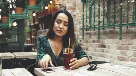 Young-woman-sipping-a-cold-drink