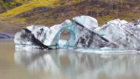 Rotation-of-a-blue-and-black-glacier-in-the-water-of-a-melting-lake