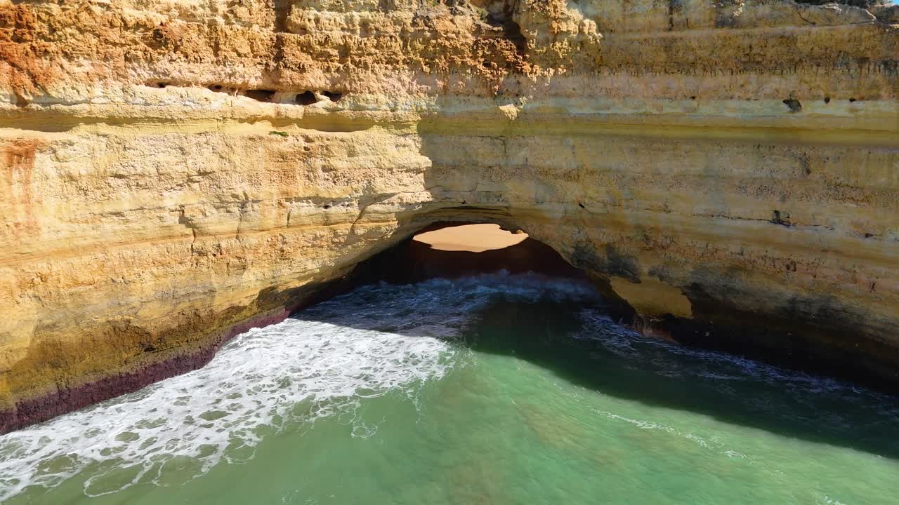 Algarve coastal landscape with cliffs and turquoise water in slow motion