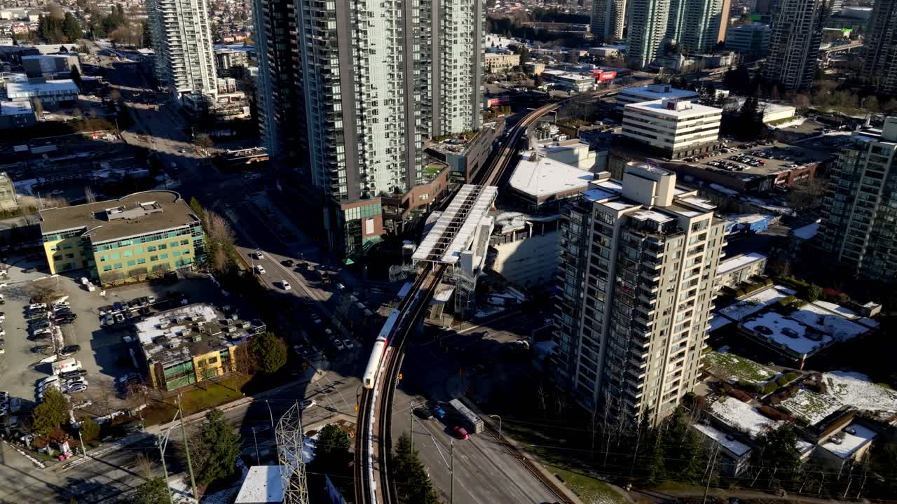 SkyTrain Leaving Gilmore Station In North Burnaby, Canada. - aerial shot