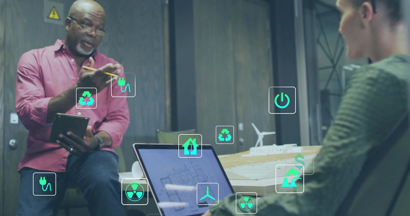 Lead gesturing while designer operating laptop starting energy icons growing over plan showing cost