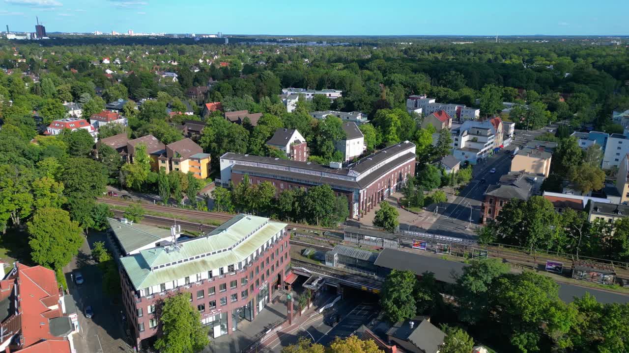 berlin zehlendorf suburb showing buildings and s bahn train station on a sunny summer day. Stunning aerial view flight overflight flyover drone