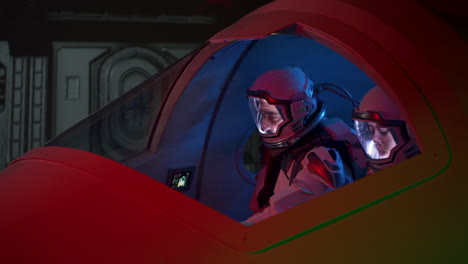 astronauts in space simulation cockpit