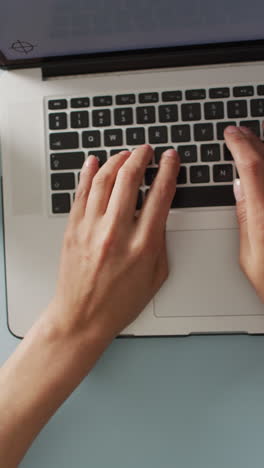 video vertical de las manos usando una computadora portátil con espacio para copiar