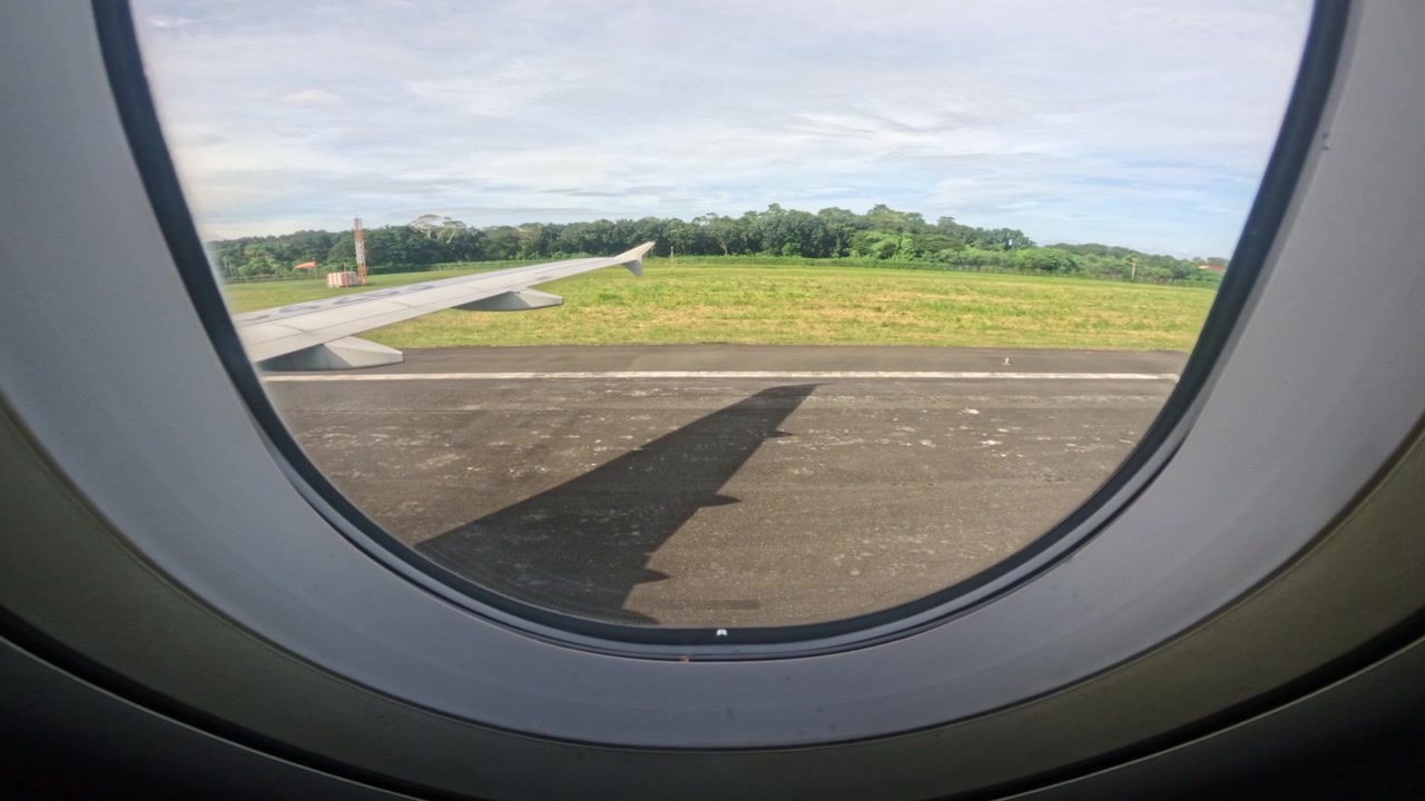 Airplane lands smoothly as seen through a passenger window