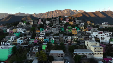 aerial view over a poor area, revealing a wealhy district, sunset in monterrey, mexico