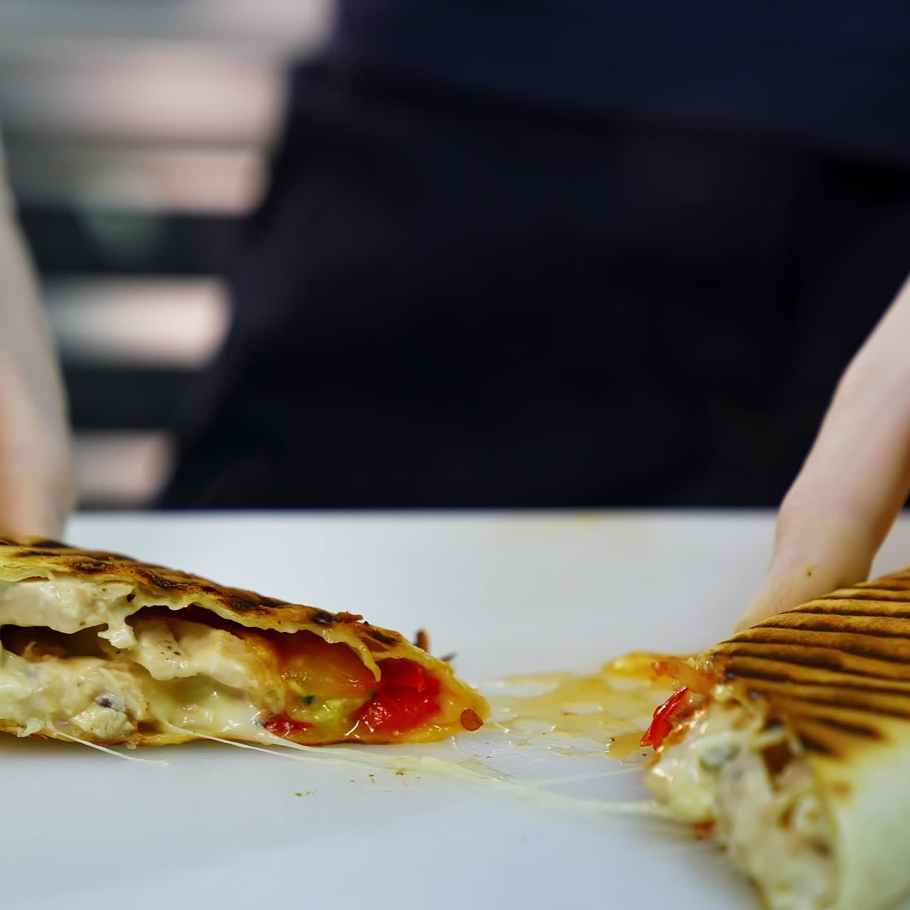 Tasty shawarma with tomatoes, peppers and sauces that make up its composition are laid out on a lacquered table cut in a half