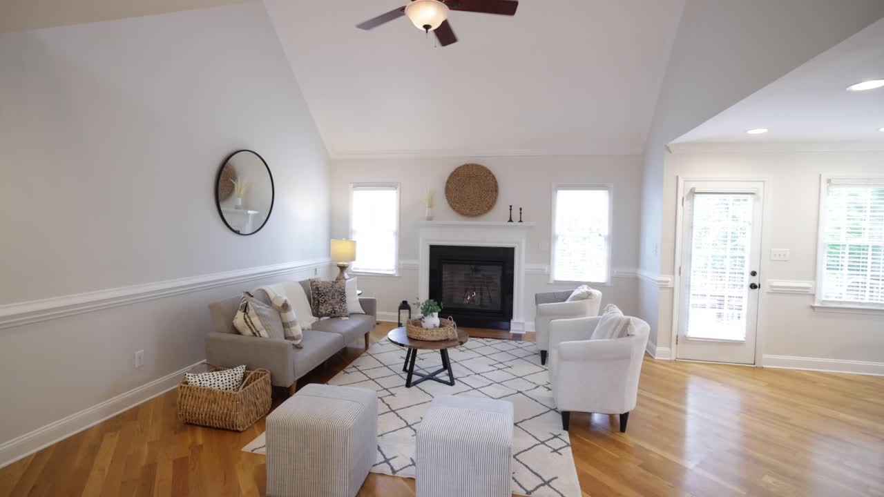 Luxury living room design with fireplace and mirror. Slow motion video.