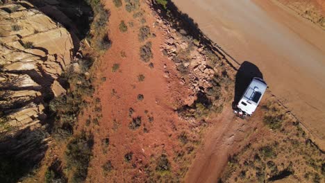 a van crawling out of a dirt road