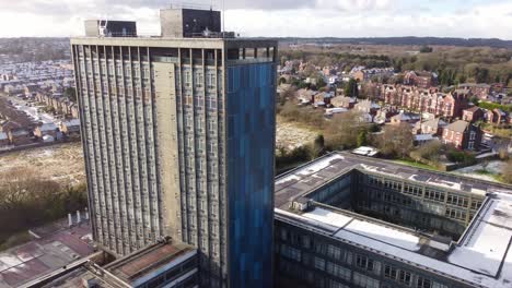 Pilkingtons-glass-head-quarters-blue-high-rise-business-office-park-aerial-view-close-to-orbiting-pull-back