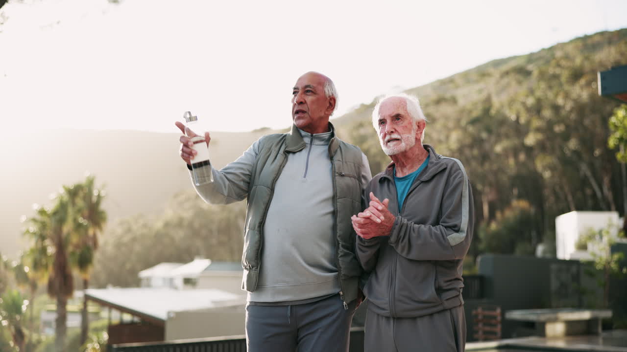 Two elderly men talking outdoors