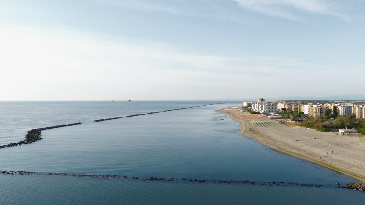 Drone view of italian sandy beaches with umbrellas and gazebos.Summer vacation concept.Lido Adriano town,Adriatic coast, Emilia Romagna,Italy.
