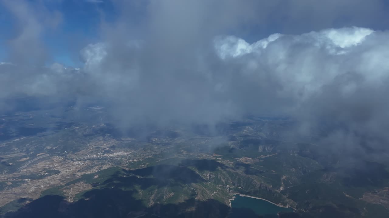 A pilot’s eye FPV from the cockpit of a jet flying through cottony stracocumulus clouds under a deep blue sky