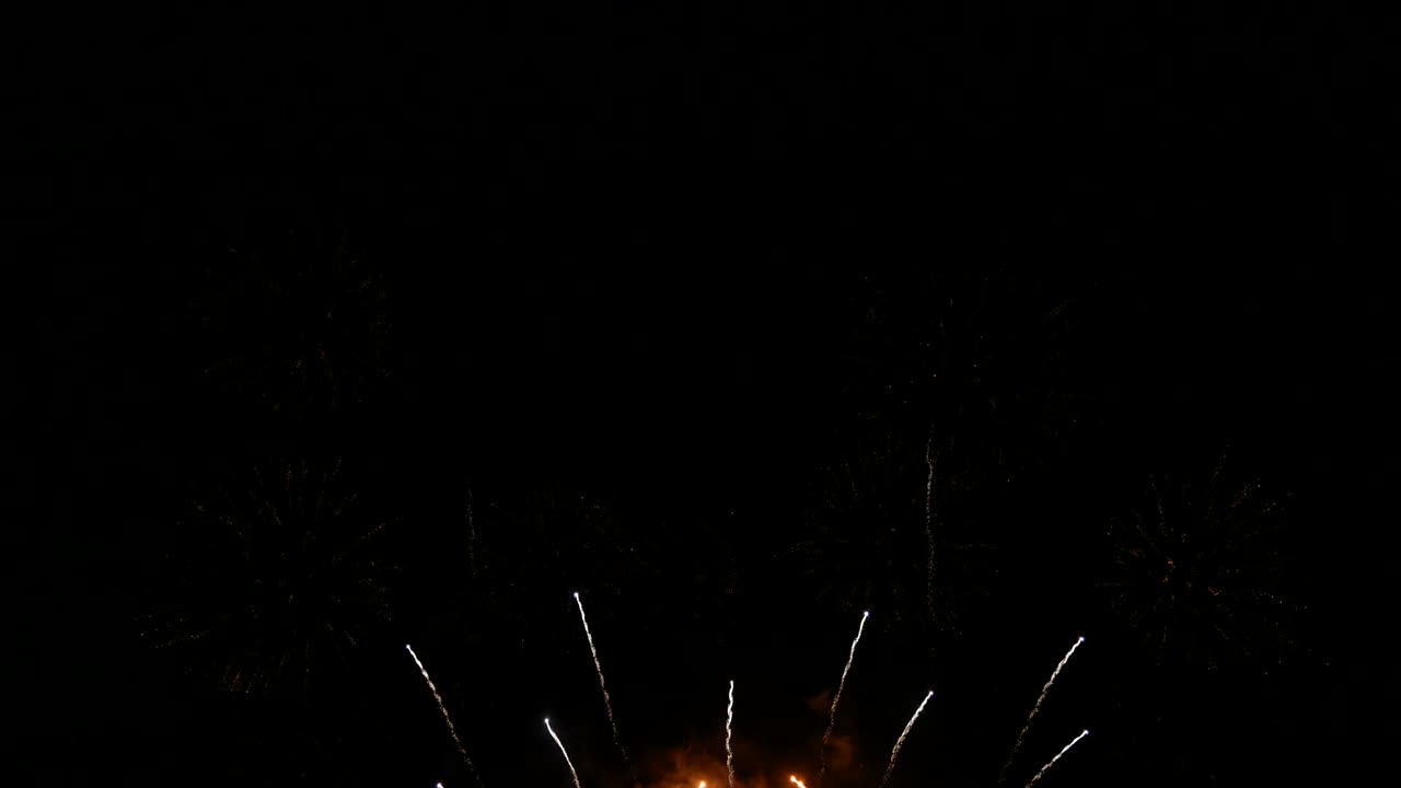 4K. beautiful combo set of real colorful fireworks background during new year's eve countdown celebration, real golden shining fireworks festival in the sky display at night. glowing fireworks show.