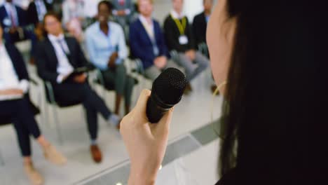 Female-speaker-speaks-in-a-business-seminar-4k