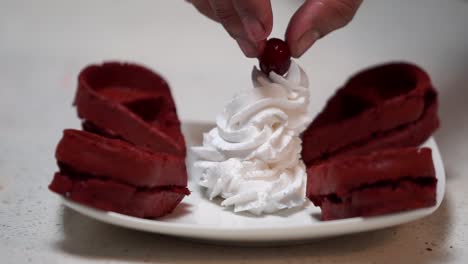 putting cheery on whipped cream