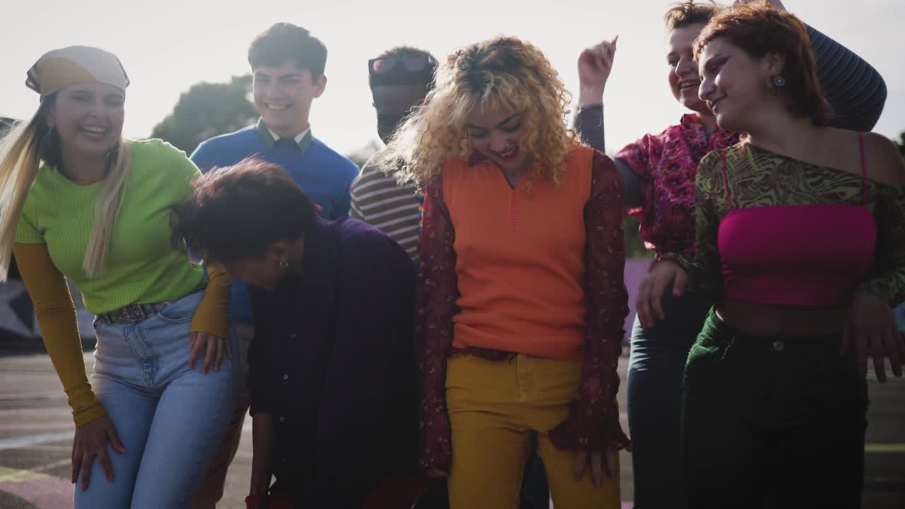 Happy young diverse friends having fun dancing together outdoor - Youth people millennial generation concept