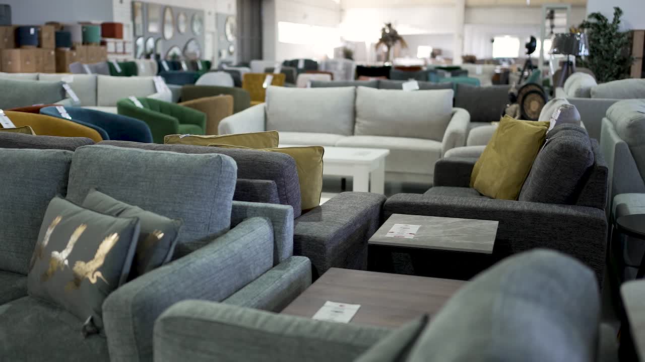 Explore a spacious furniture showroom showcasing a variety of comfortable sofas, armchairs, and coffee tables. A perfect place for unique home furnishings and decor ideas