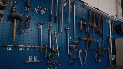 organized tools hanging on a blue pegboard in a workshop. perfect for diy or industrial project visuals