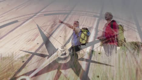 caucasian senior couple hiking in countryside pointing, over turning compass