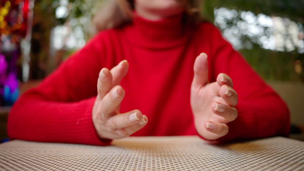 Woman in red sweater having a conversation and gesticulating with hands