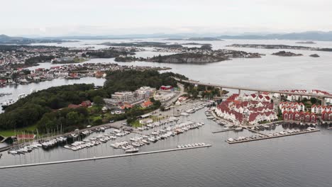 aerial view of stavanger city norway waterfront, grasholmen island, boats in marina and bybrua road overpass, drone shot