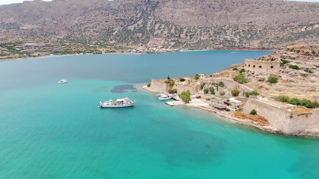 Touristic cruise boats near Island of Spinalonga, Mediterranean sea. Aerial