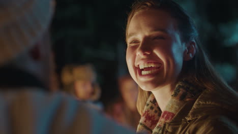 happy woman laughing chatting to man having conversation enjoying romantic connection flirting by campfire 4k
