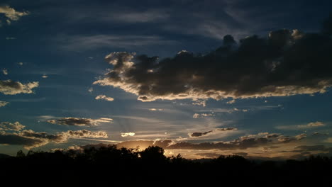 sunset with birds flying across the sun and flatirons