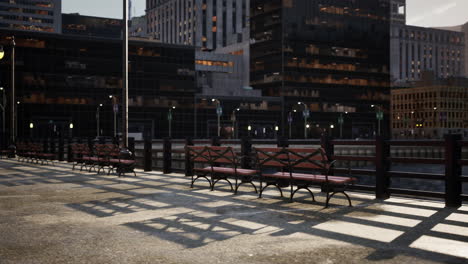 a row of benches along a river in a city