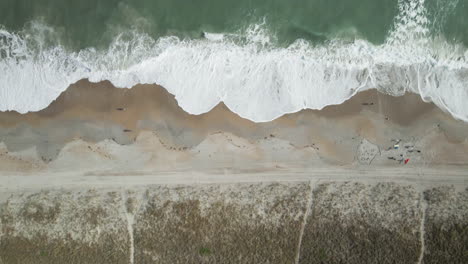 top-down aerial from shoreline to breaking waves and foam wrightsville beach